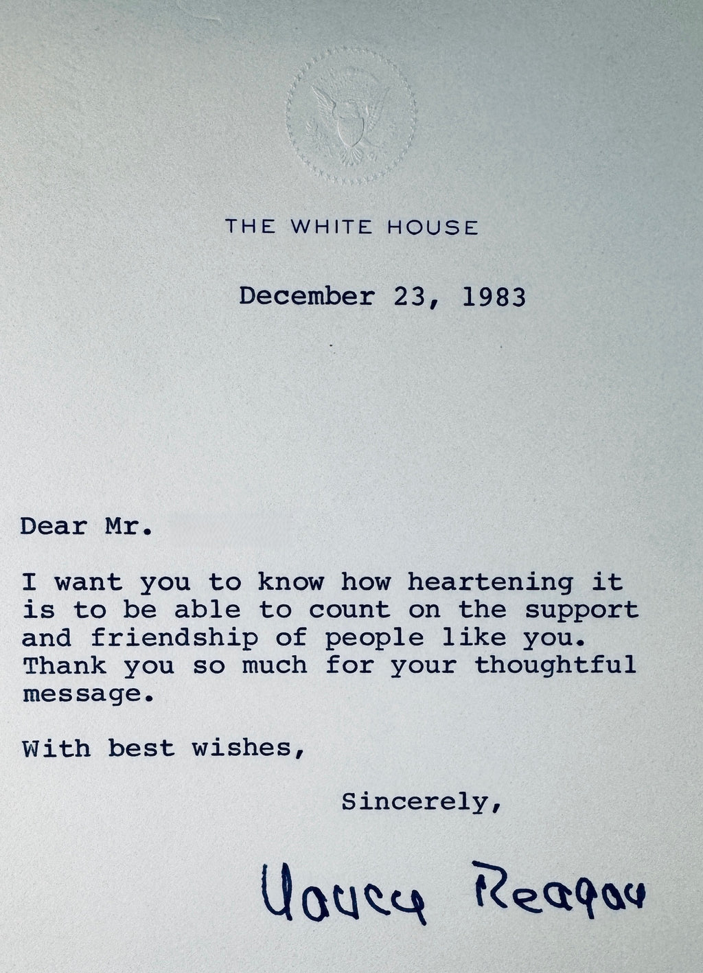 Close-up view of 1983 White House letterhead showing the embossed presidential seal, date, typed text, and Nancy Reagan printed signature.