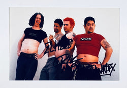 Autographed 5x7 color promotional photograph of punk rock band NOFX wearing crop top t-shirts, signed in black marker by band members.