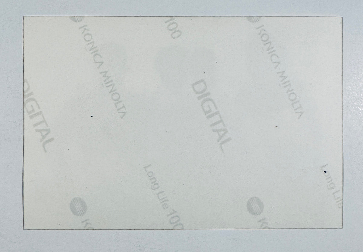 Reverse side of original color photo print showing Konica Minolta Digital Long Life 100 paper watermark backprint.