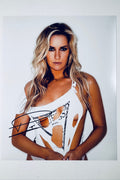 Signed 8x10 matte photo of Paige Spiranac wearing a distressed white Guess top, featuring a bold black ink autograph.