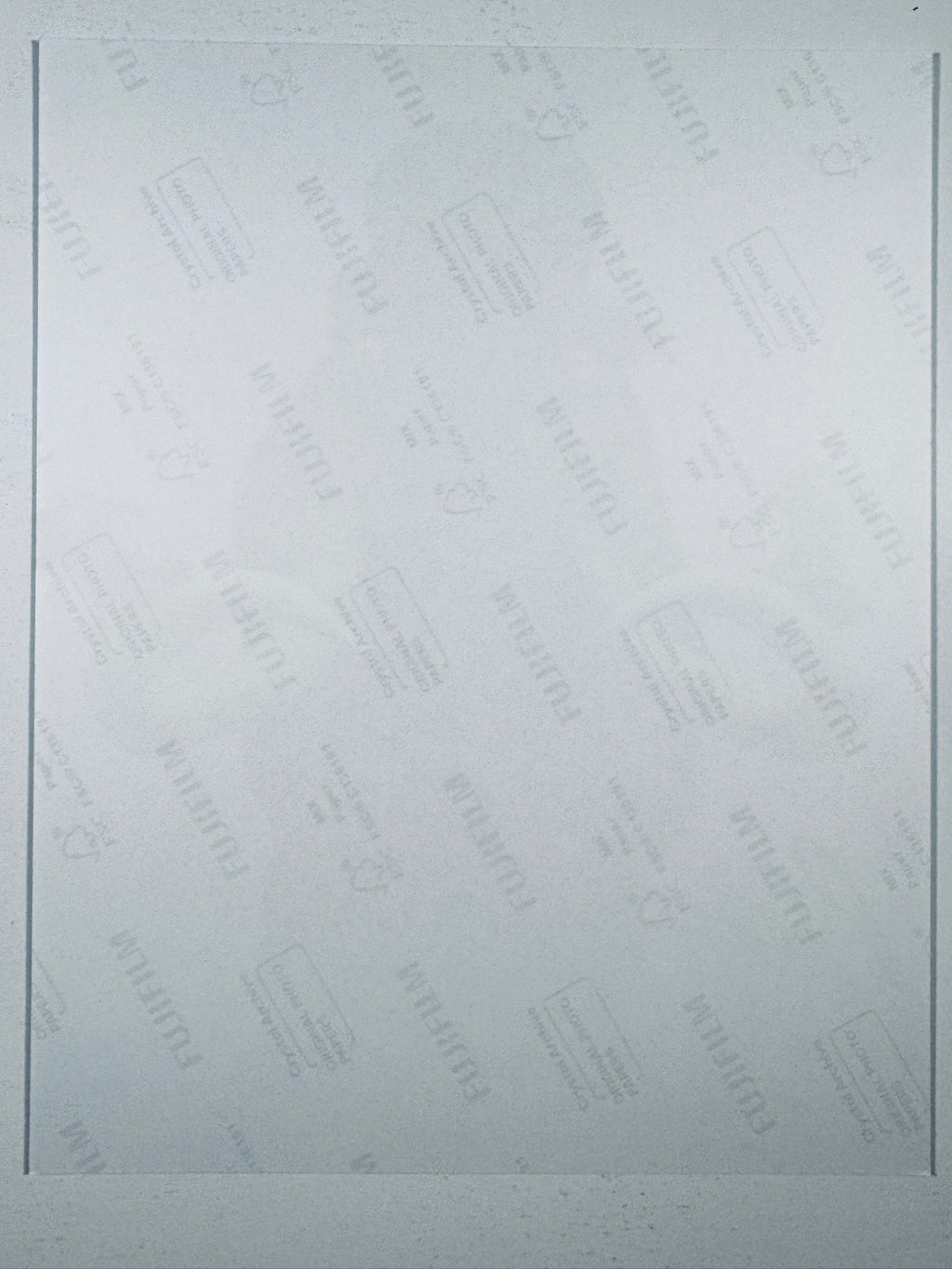 The plain white reverse side representing the back physical condition of the photograph print, showing translucent Fujifilm crystal archive paper watermarks and logos.