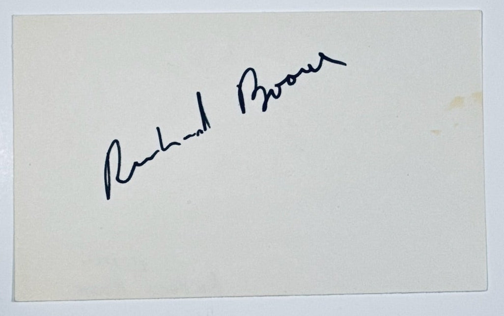 A close-up view of a 3x5 index card featuring an authentic hand-signed autograph by actor Richard Boone.