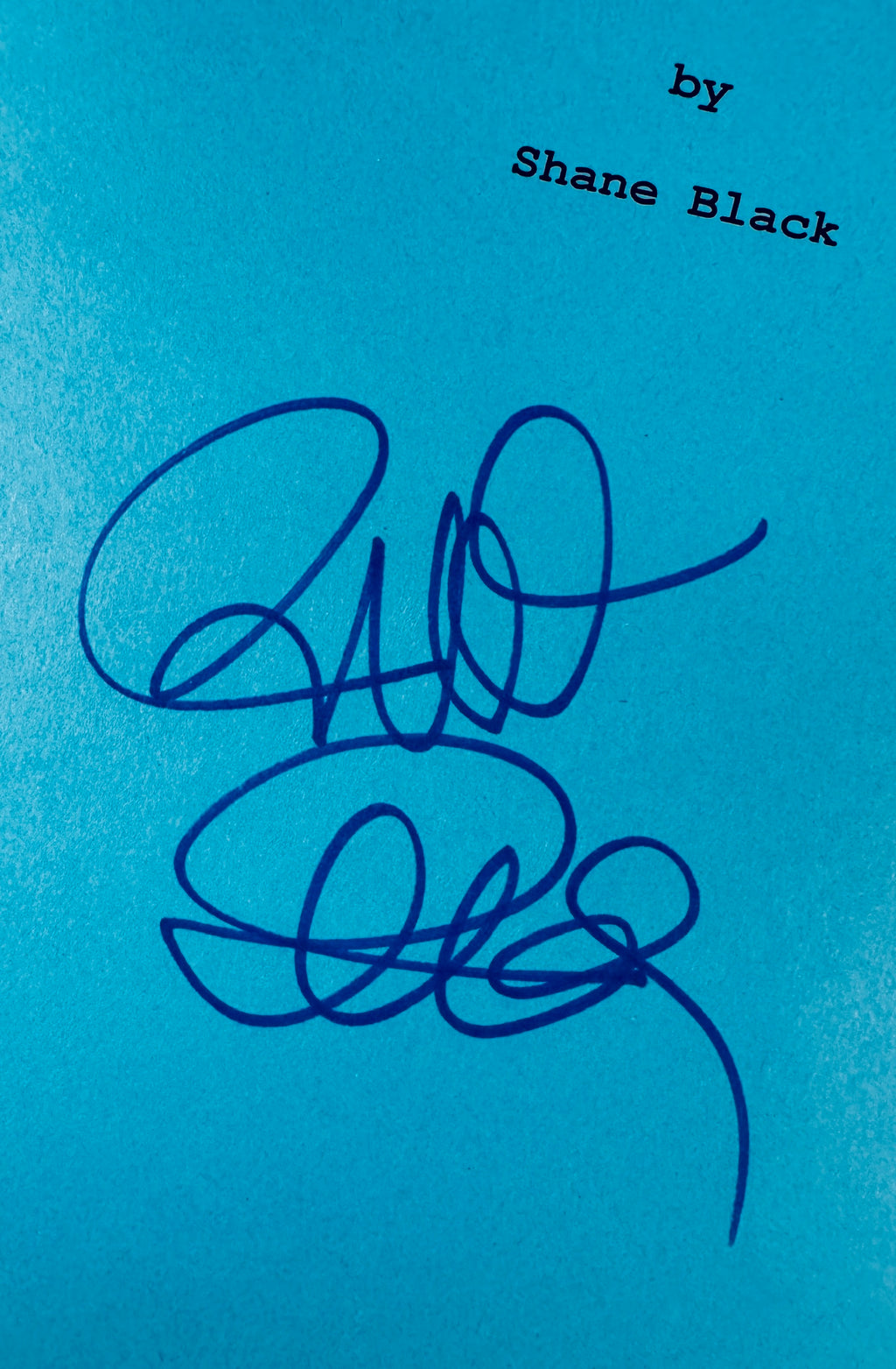 Close-up view of Richard Donner autograph signature in blue marker under the printed writer credit.