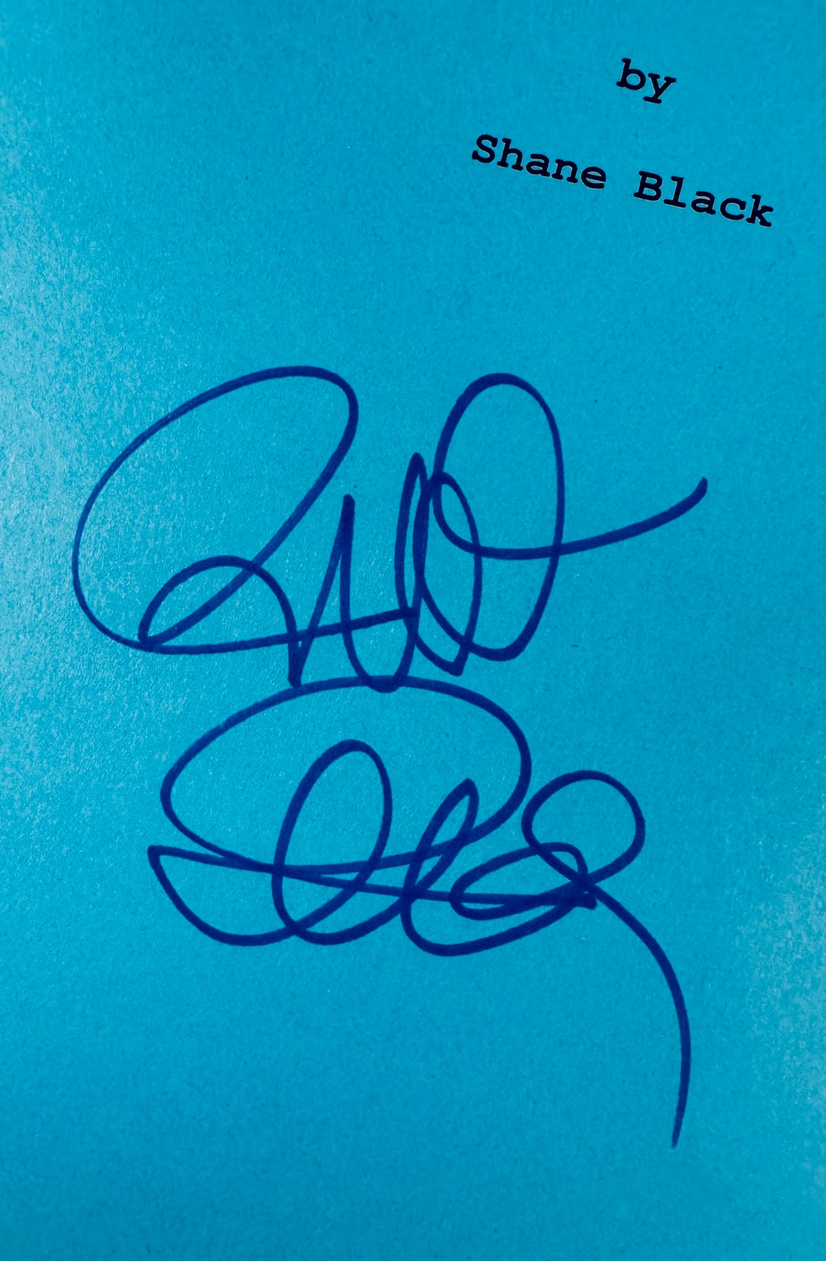 Close-up view of Richard Donner autograph signature in blue marker under the printed writer credit.