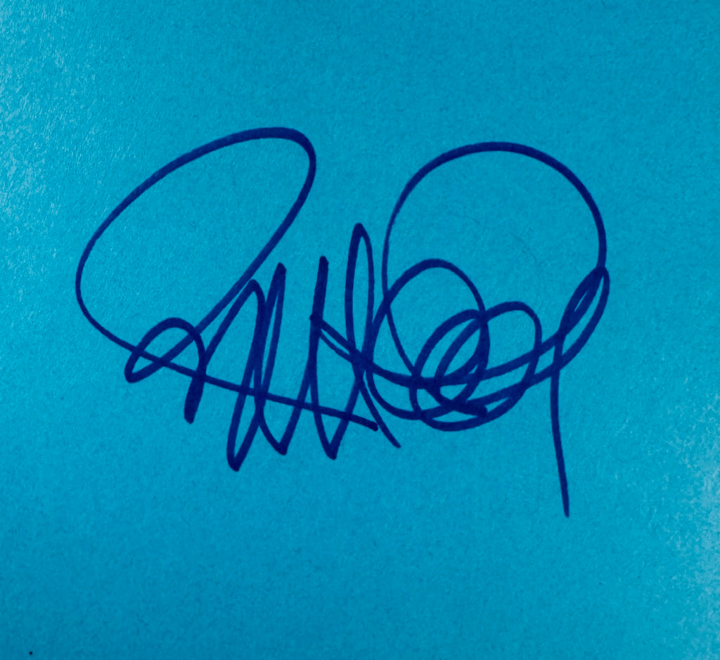 Close-up view of Richard Donner autograph signature written in blue marker.