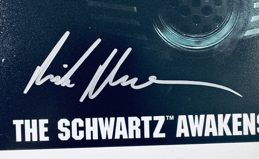 Close-up of Rick Moranis's signature in silver marker on the signed Spaceballs: The New One 8x10 photo.
