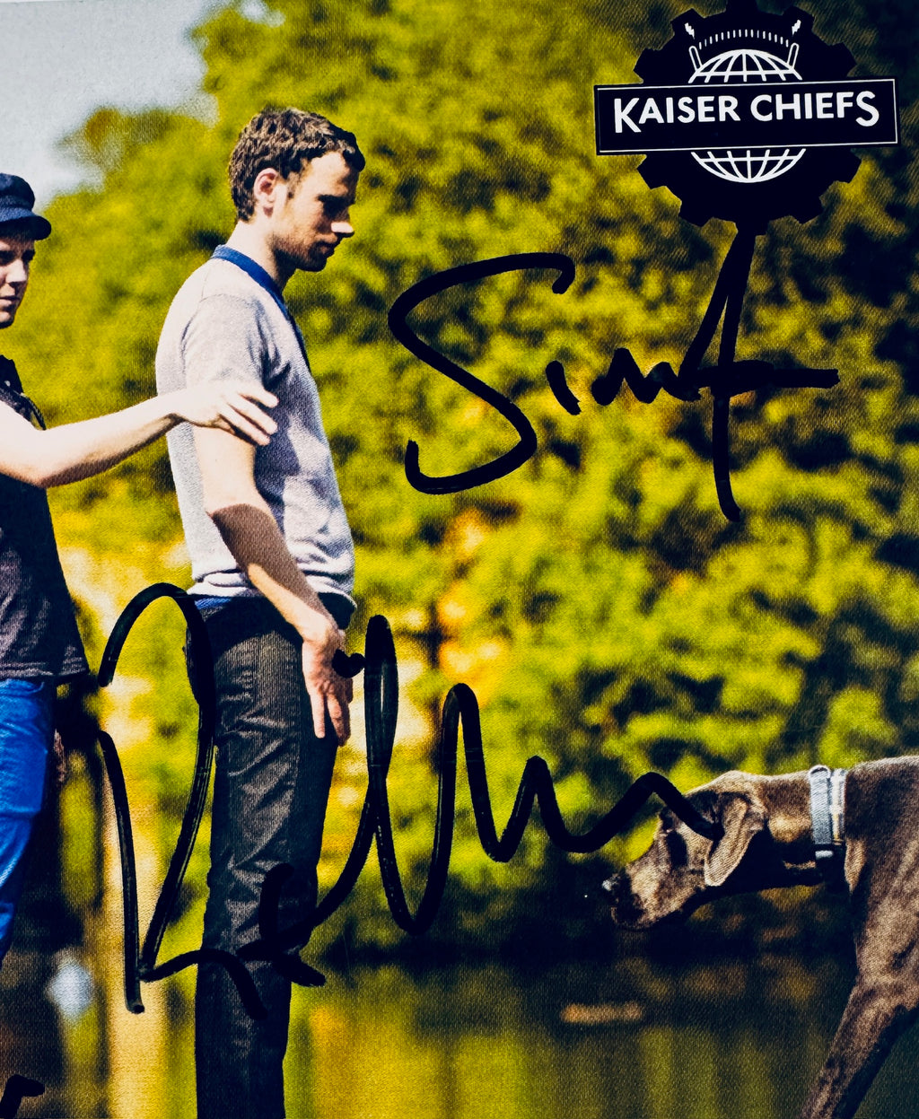 Close-up view of signatures from Ricky Wilson and Simon Rix alongside Kaiser Chiefs logo.