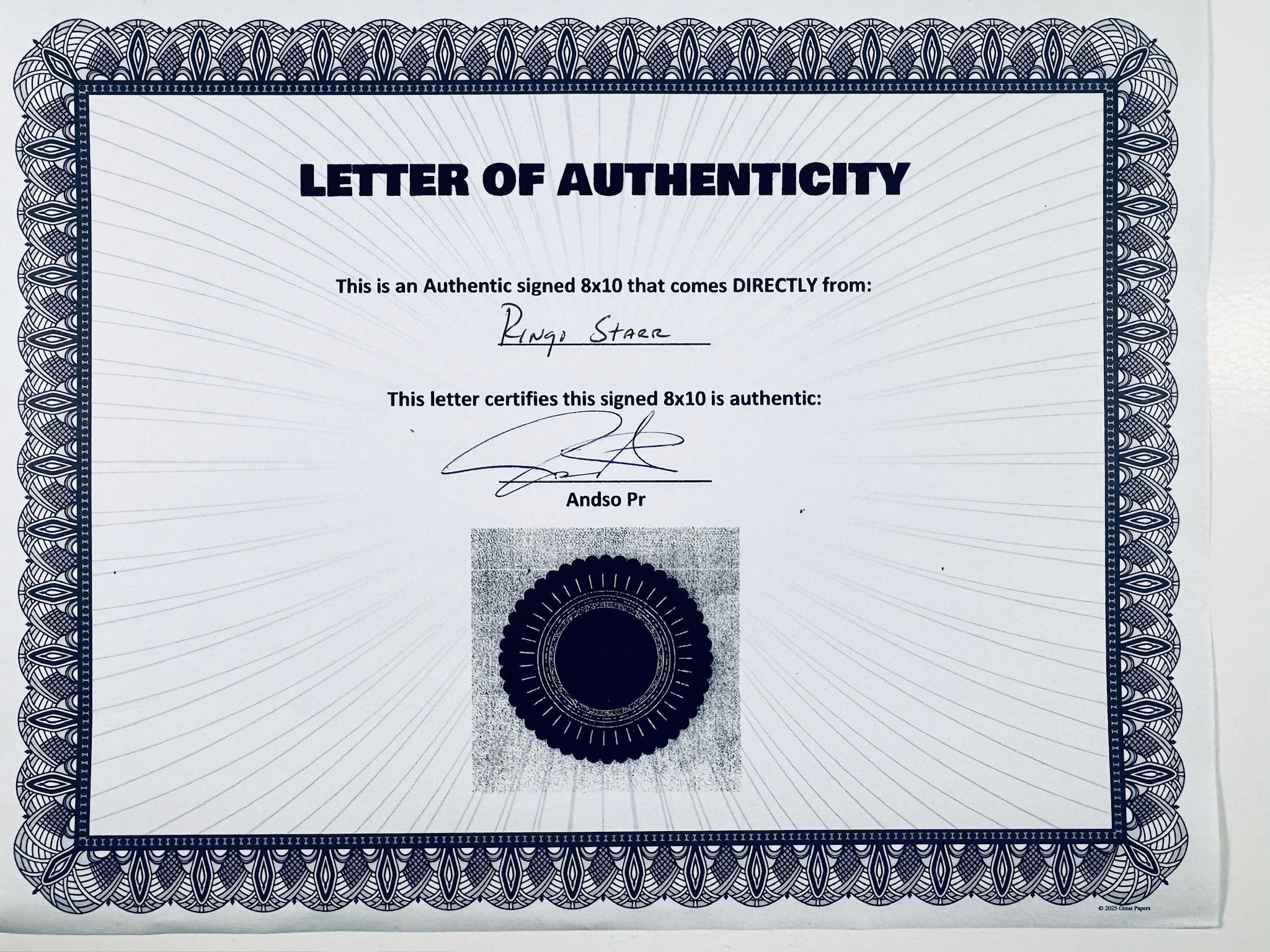 A Letter of Authenticity with a decorative blue-patterned border, certifying an authentic signed 8x10 coming directly from Ringo Starr, featuring a dark circular seal graphic at the bottom.