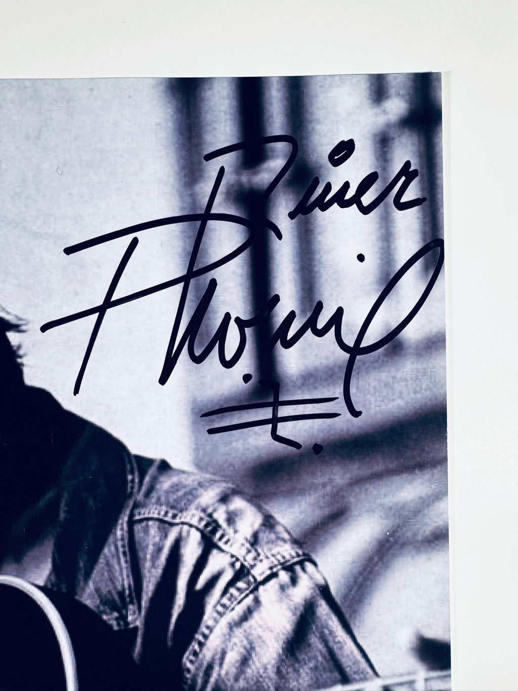 Close-up view of River Phoenix authentic black ink signature on 8x10 portrait photo.