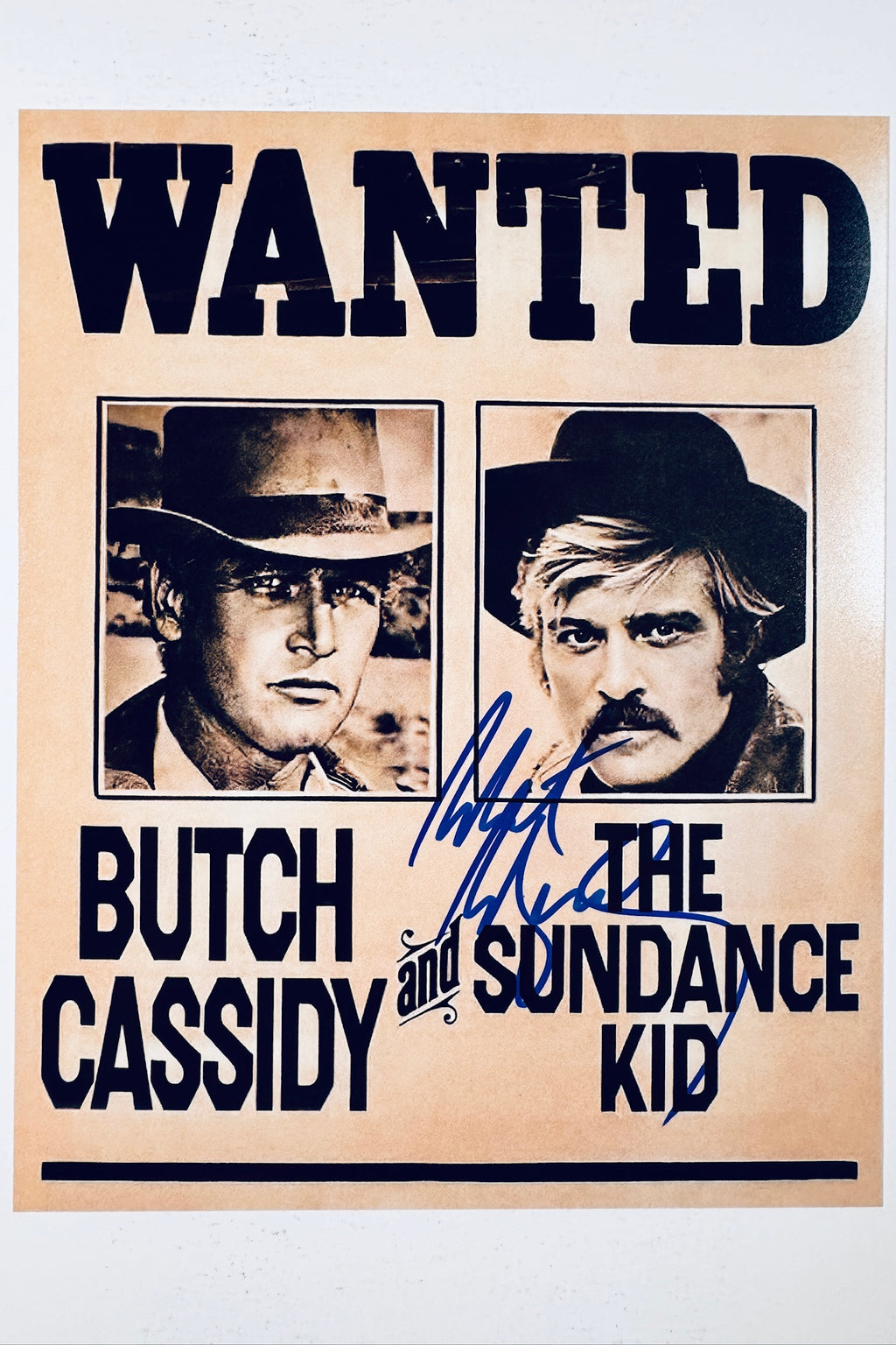 Vintage wanted poster photo from Butch Cassidy and the Sundance Kid featuring Paul Newman and Robert Redford, with a bold blue ink autograph exclusively by Robert Redford.