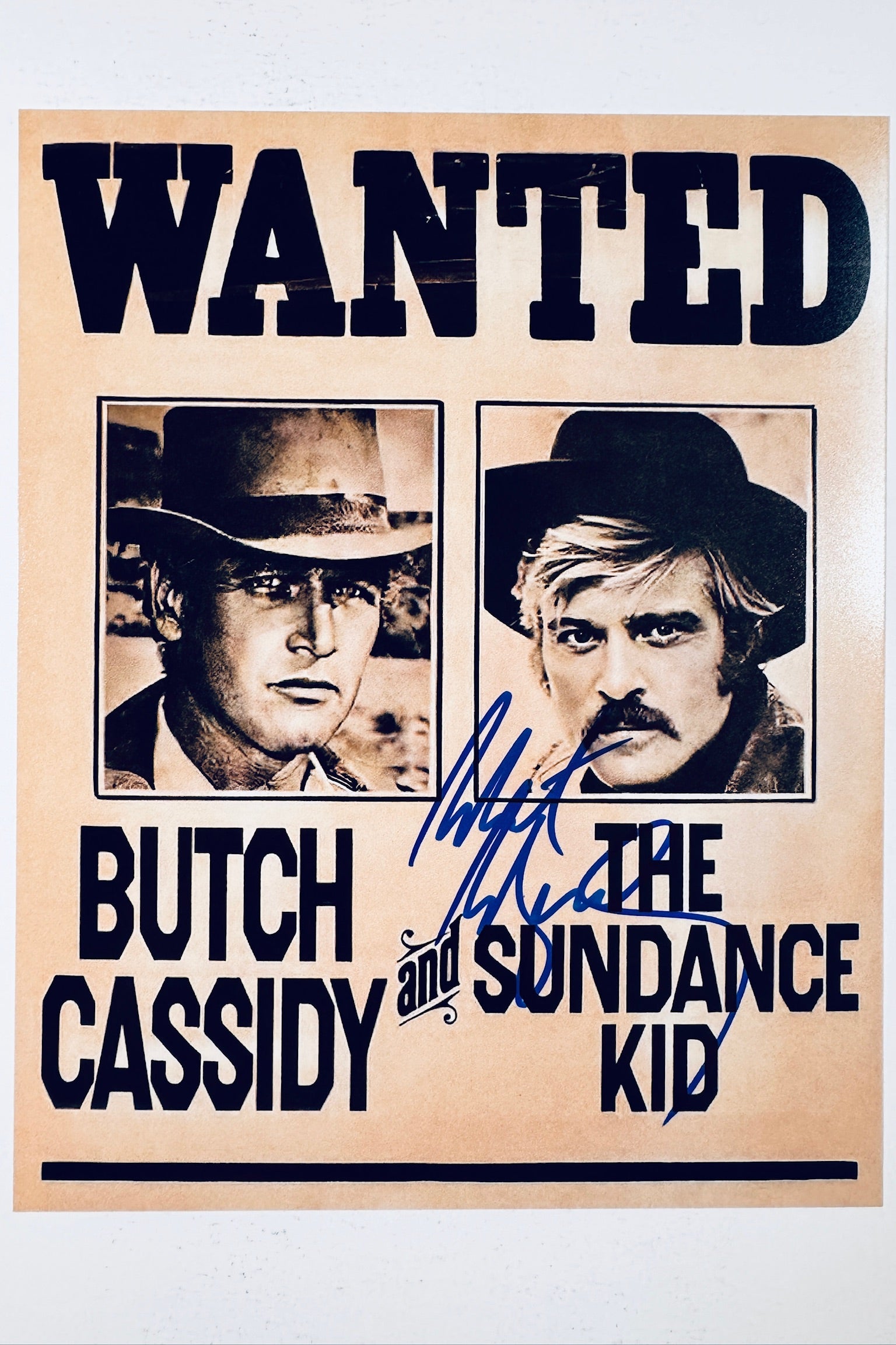Vintage wanted poster photo from Butch Cassidy and the Sundance Kid featuring Paul Newman and Robert Redford, with a bold blue ink autograph exclusively by Robert Redford.