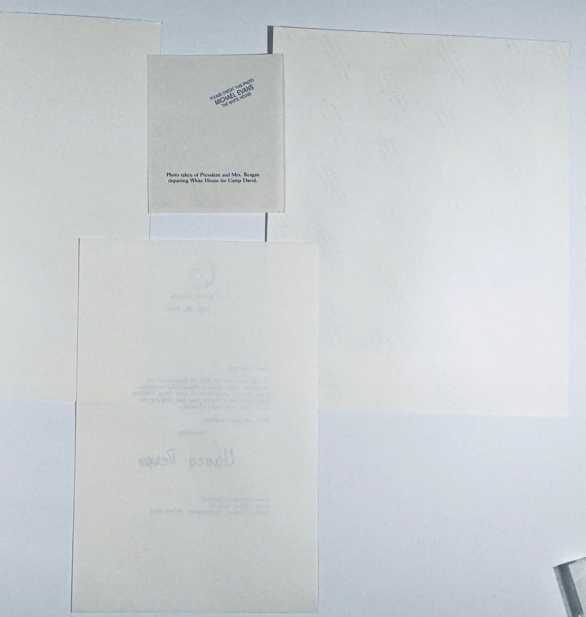 Backside of vintage Ronald and Nancy Reagan photograph showing official White House photographer Michael Evans credit stamp and caption clip slip.