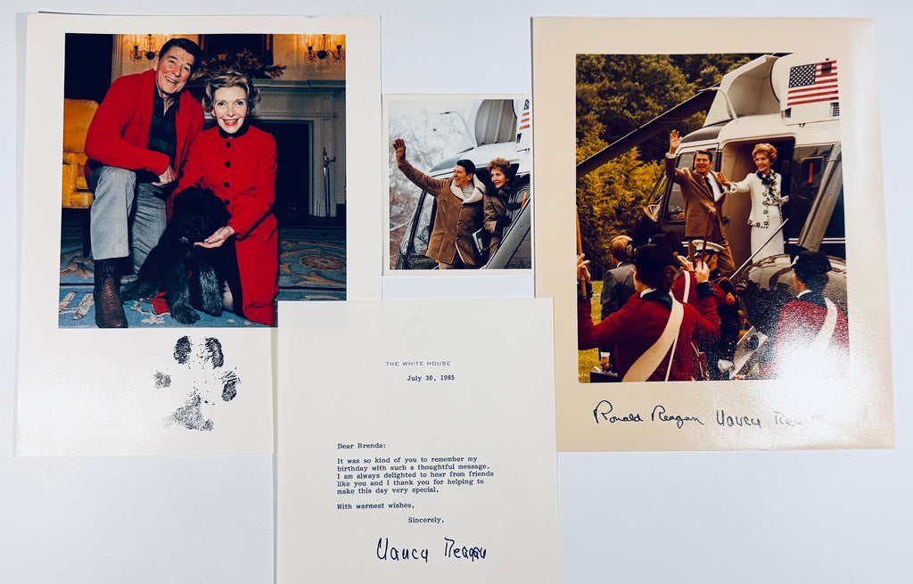 Overview display of Ronald and Nancy Reagan autographed photo set, official White House letter, and snapshot.