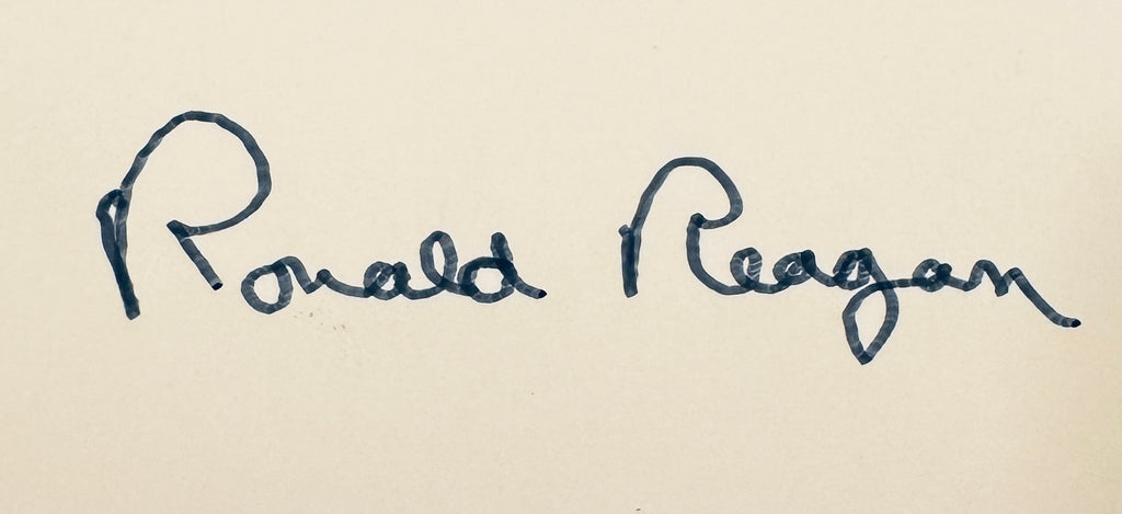 Close-up macro detail of President Ronald Reagan signature in dark ink.