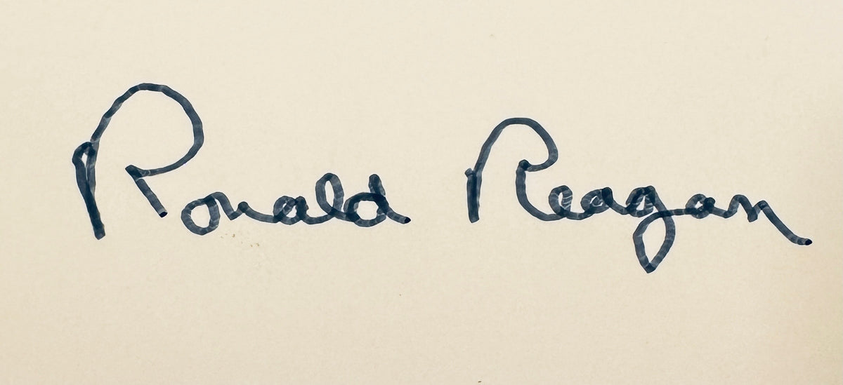 Close-up macro detail of President Ronald Reagan signature in dark ink.