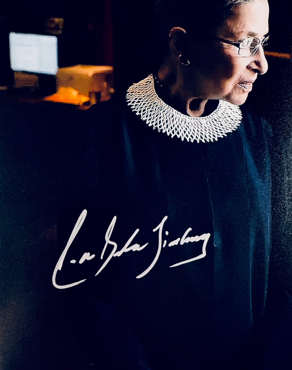 Close-up of Ruth Bader Ginsburg's signature in silver marker on the signed Supreme Court 8x10 photo.