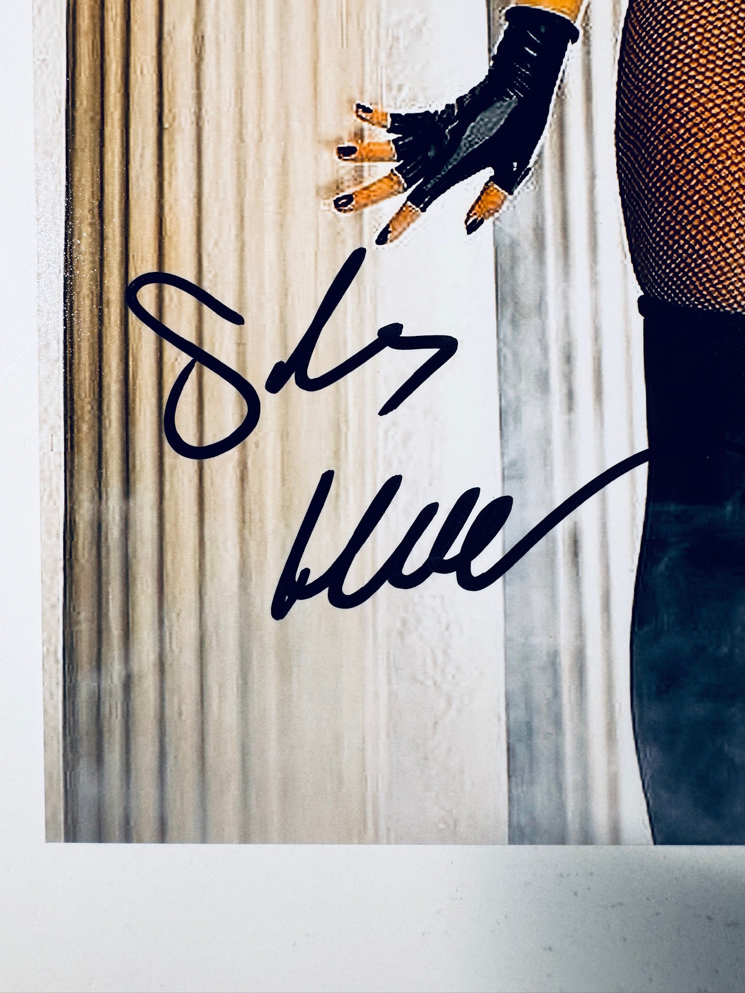 Close-up view of Sarah Michelle Gellar's black signature across the lower corner of the Buffy the Vampire Slayer promotional photograph.