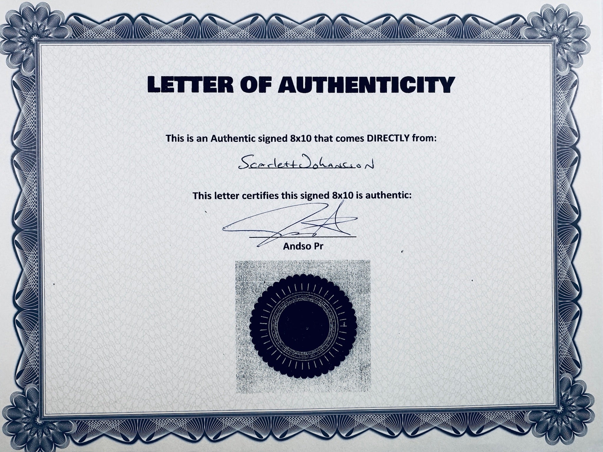 A Letter of Authenticity with a decorative blue-patterned border, certifying an authentic signed 8x10 coming directly from Scarlett Johansson, featuring a dark circular seal graphic at the bottom.