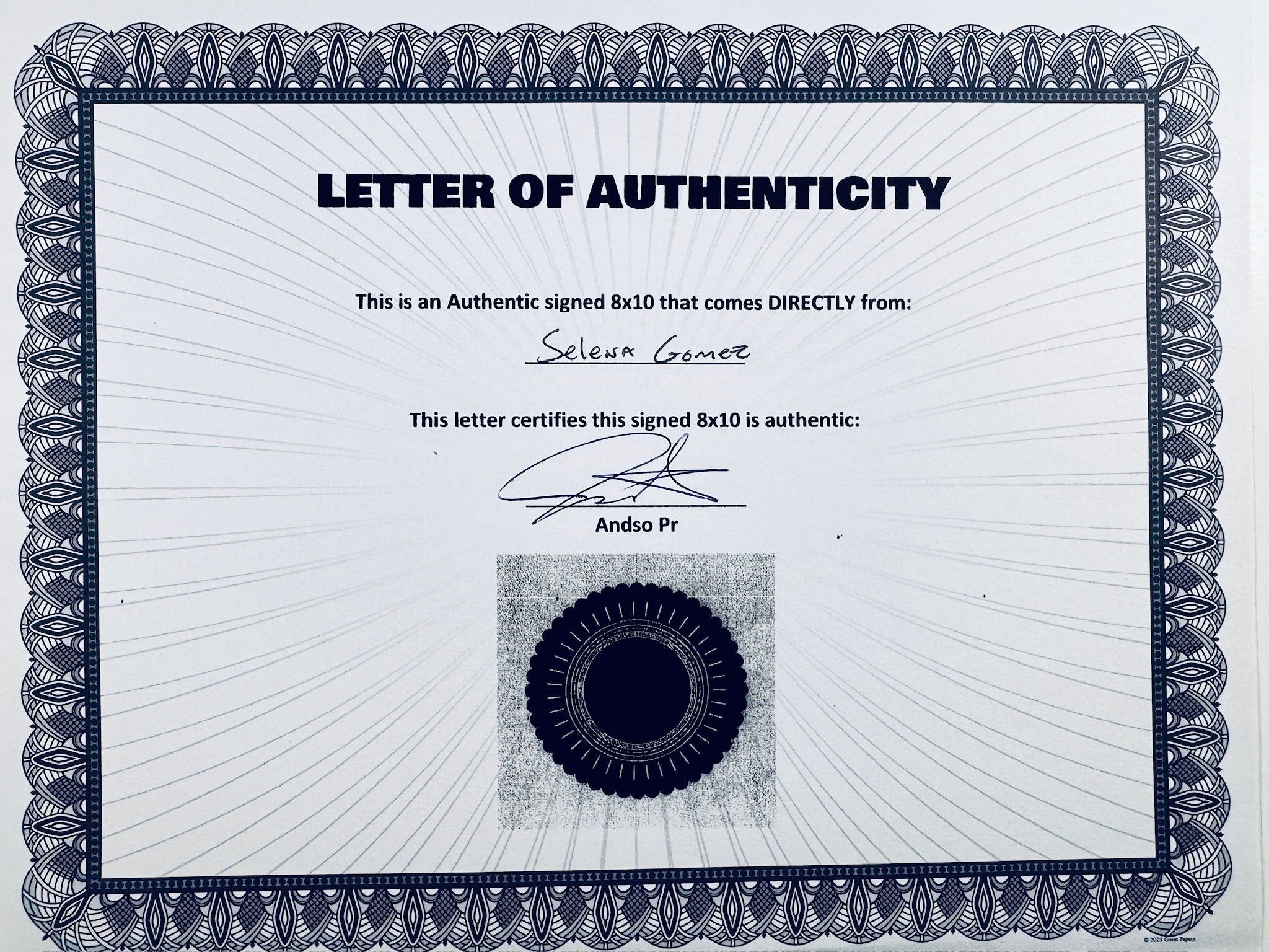A Letter of Authenticity with a decorative blue-patterned border, certifying an authentic signed 8x10 coming directly from Selena Gomez, featuring a dark circular seal graphic at the bottom.