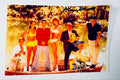Full-shot autographed color photograph of the Gilligan's Island cast hand-signed by show creator Sherwood Schwartz.