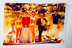 Full-shot autographed color photograph of the Gilligan's Island cast hand-signed by show creator Sherwood Schwartz.