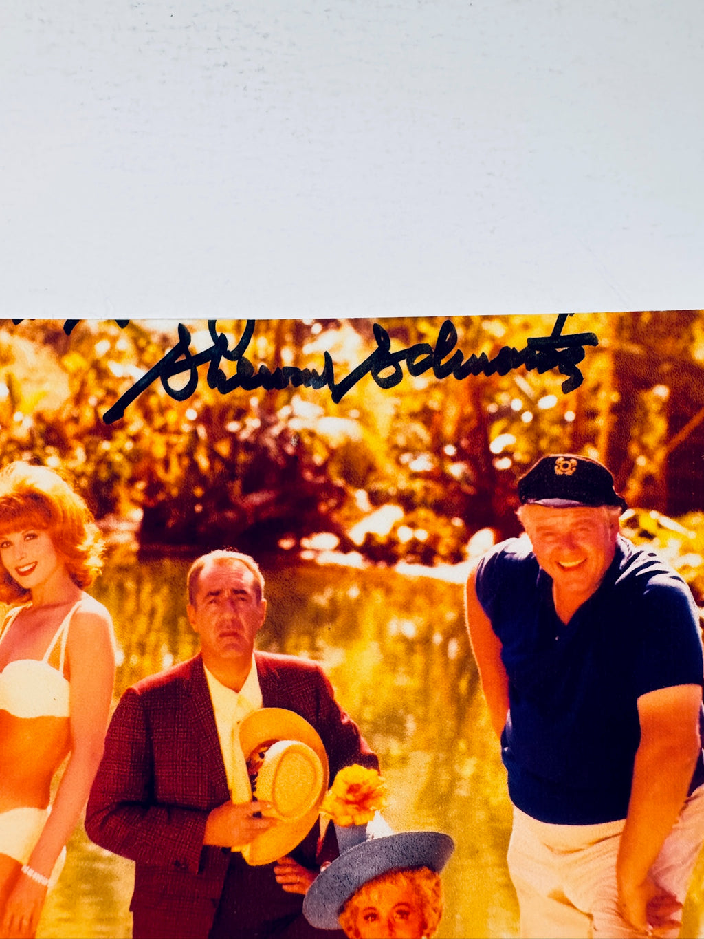 Cropped upper section of signed Gilligan's Island photo showing the autograph above cast members.