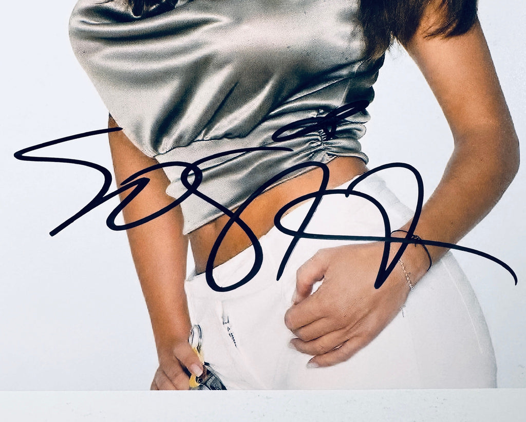 Close-up of Sofia Vergara's signature in black marker on the signed 8x10 photo.
