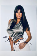 Sofia Vergara hand-signed 8x10 matte promotional photo wearing a metallic top and white pants.