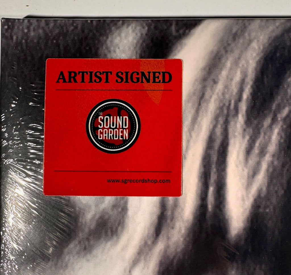 Close-up of the red "Artist Signed" sticker from The Sound Garden record shop attached to the shrink wrap.