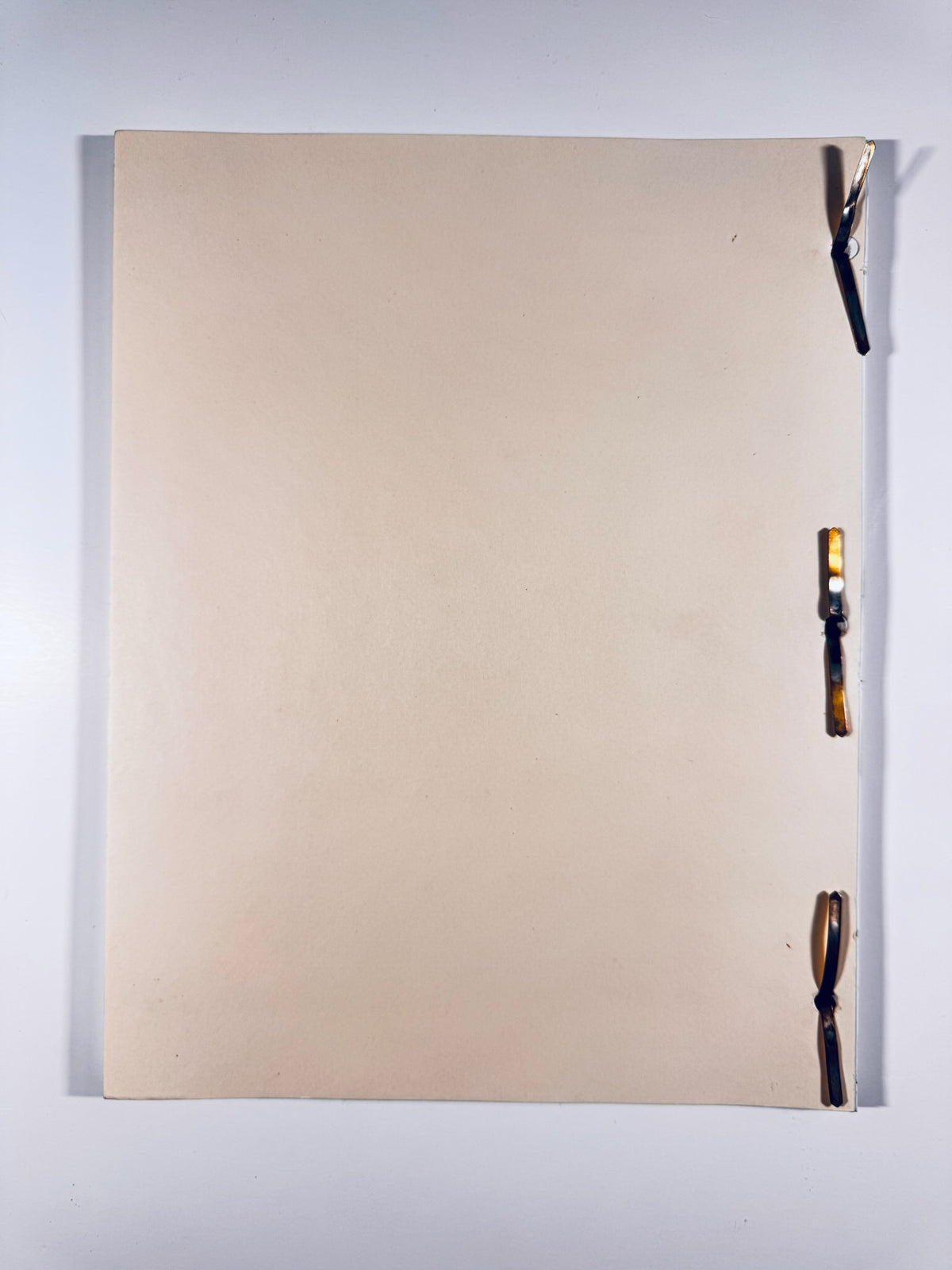 Back cover of vintage Spin City production script held together with brass brad fasteners