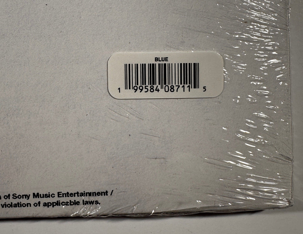 Close-up of the back cover barcode sticker indicating the "BLUE" vinyl color variant (UPC 199584087115).