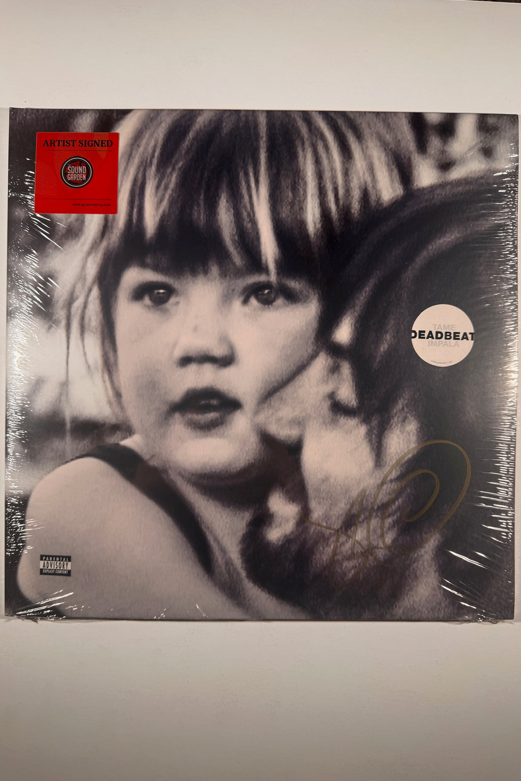 Front cover of factory-sealed Tame Impala Deadbeat vinyl album with gold artist signature, hype sticker, and red Sound Garden Artist Signed sticker.