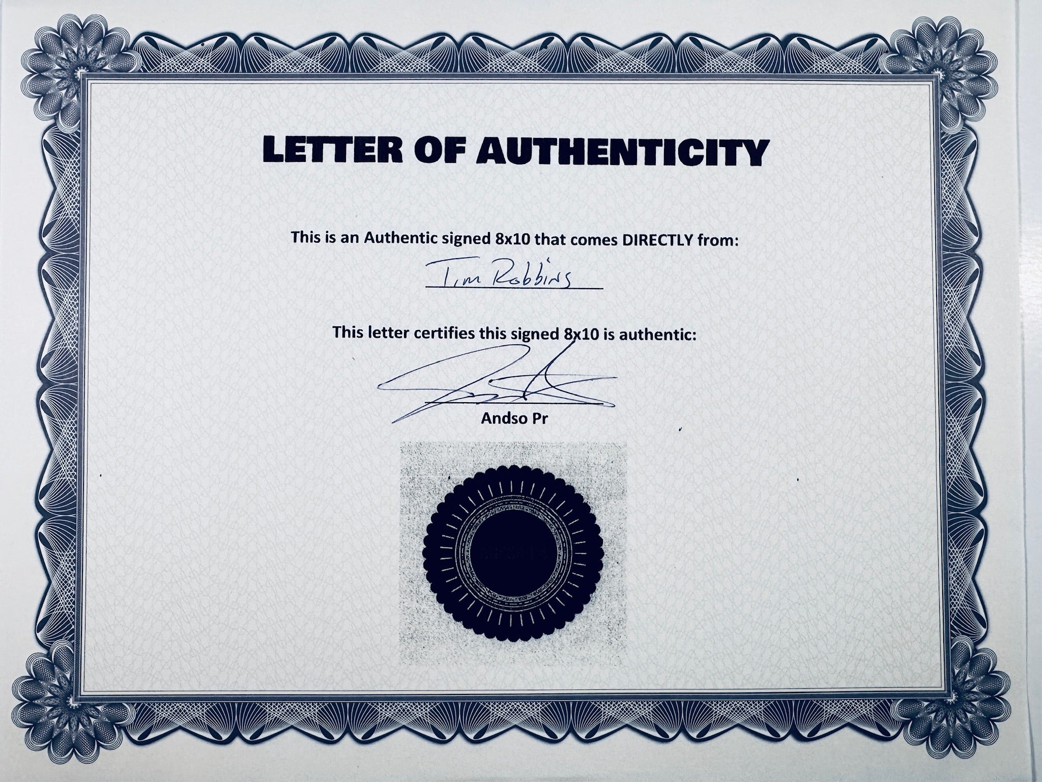 A Letter of Authenticity with a decorative blue-patterned border, certifying an authentic signed 8x10 coming directly from Tim Robbins, featuring a dark circular seal graphic at the bottom.