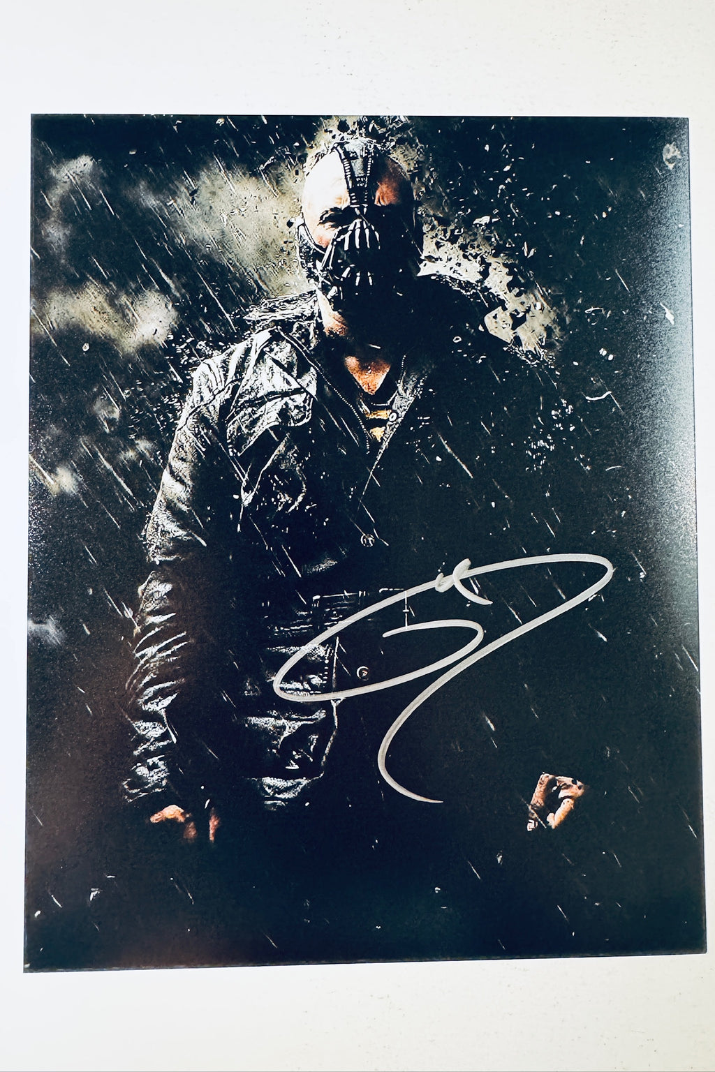 Signed full photo of Tom Hardy as Bane from The Dark Knight Rises in the rain, featuring a silver autograph.