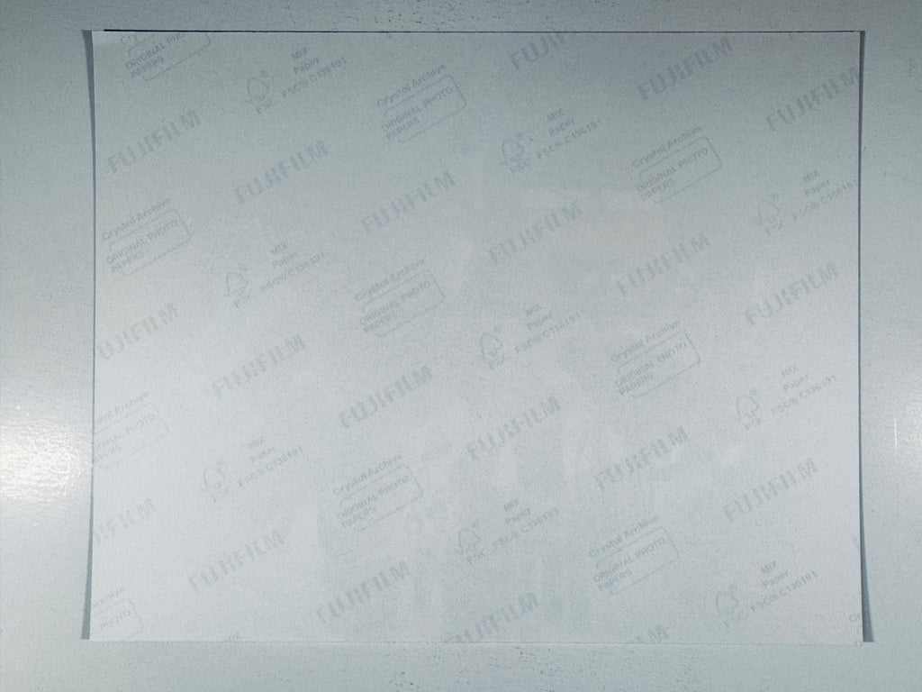 The plain white reverse side representing the back physical condition of the photograph print, showing translucent Fujifilm crystal archive paper watermarks and logos.