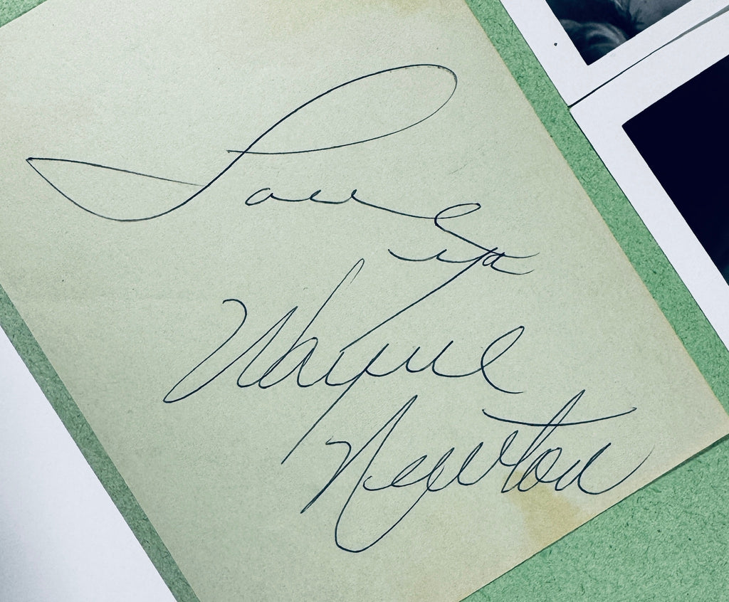 Macro close-up view of Wayne Newton autograph inscribed Love Ya Wayne Newton in fountain pen ink.