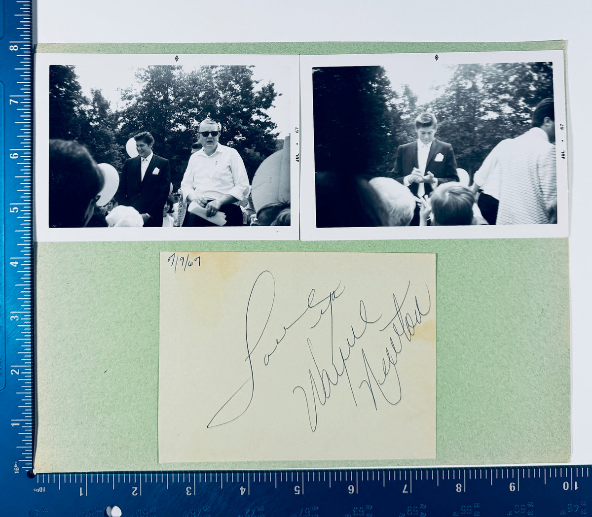 Vintage 1967 Wayne Newton autographed scrapbook display positioned beside a ruler for precise measurement.