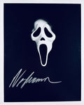 A professional 8x10 matte photograph featuring an authentic autograph by horror director Wes Craven.