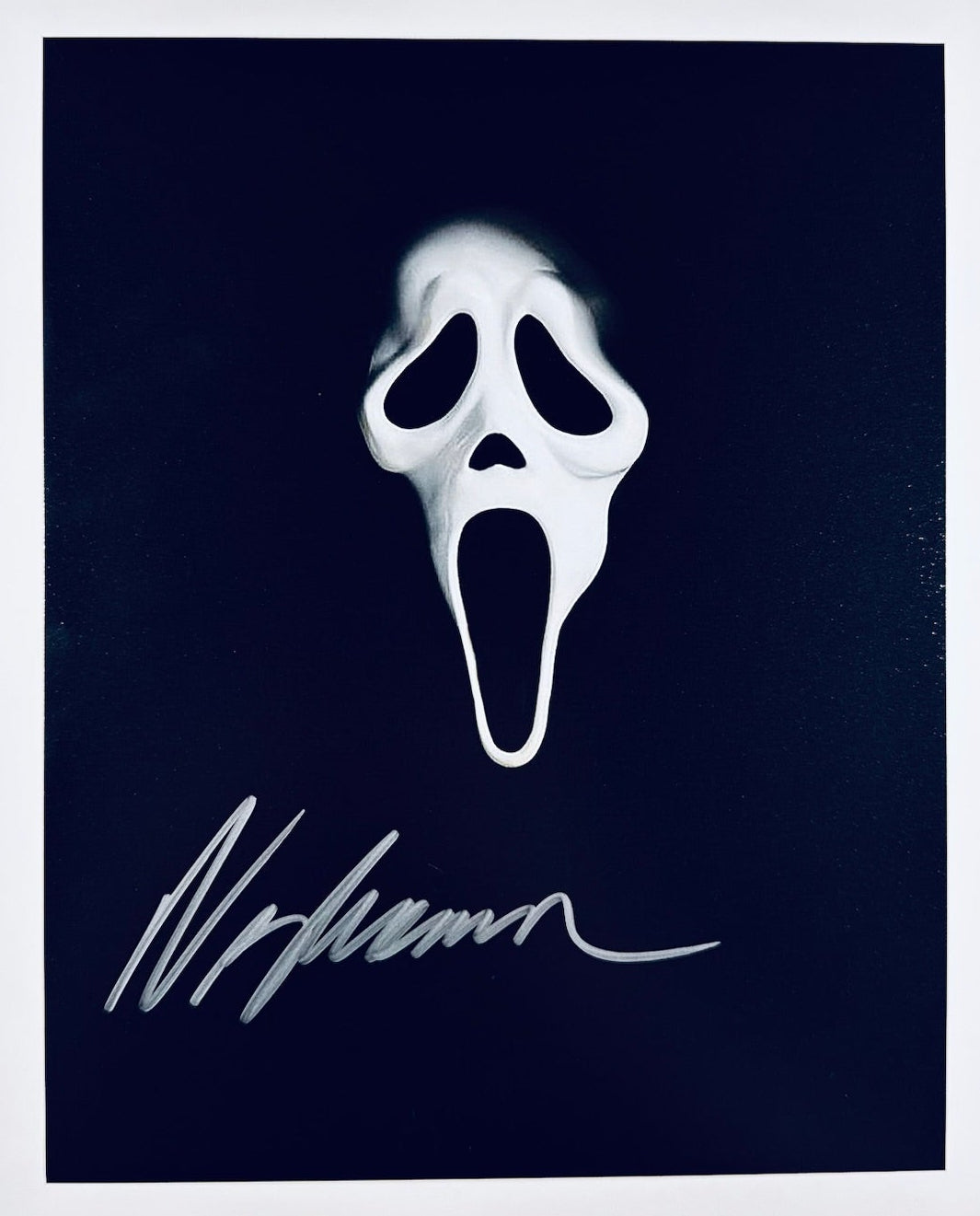 A professional 8x10 matte photograph featuring an authentic autograph by horror director Wes Craven.