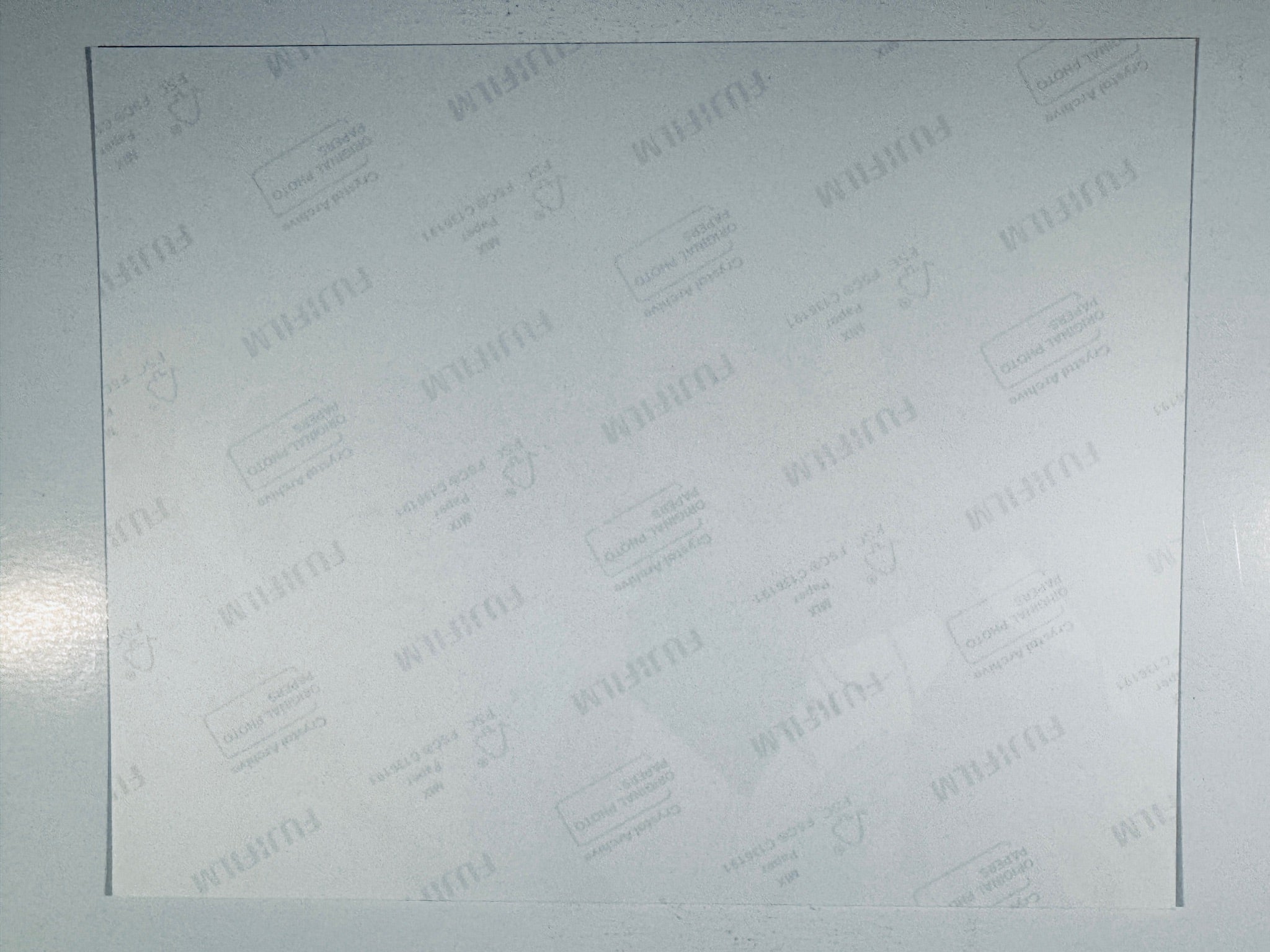 The plain white reverse side representing the back physical condition of the photograph print, showing translucent Fujifilm crystal archive paper watermarks and logos.